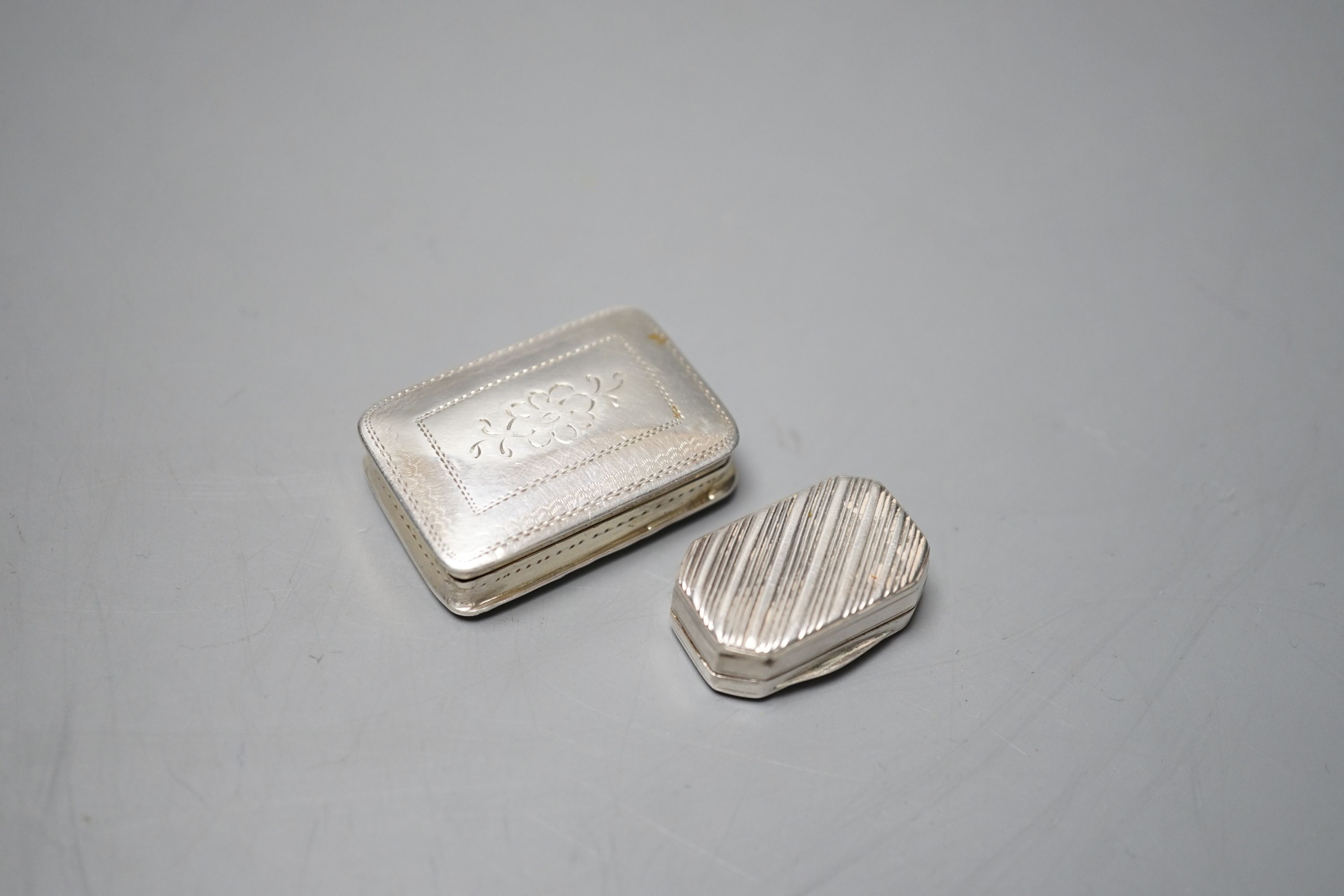 A William IV silver rectangular vinaigrette by Nathaniel Mills, Birmingham, 1836, with engraved decoration and initials, 35mm and one other earlier smaller vinaigrette, maker W?, London, 1813, 12mm.
